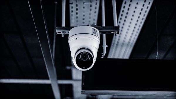 Security camera on building representing biometric data protection